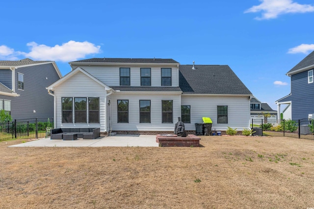 back of house with a lawn and a patio area