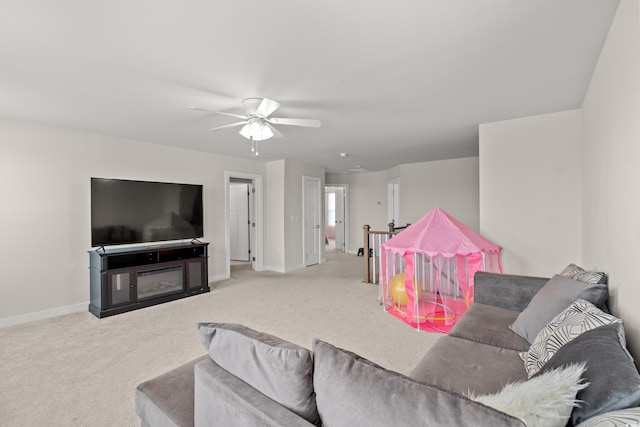 carpeted living room with ceiling fan