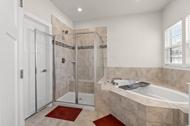 bathroom with independent shower and bath and tile patterned floors