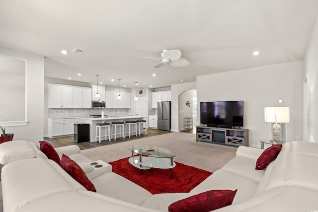 living room featuring hardwood / wood-style flooring and ceiling fan