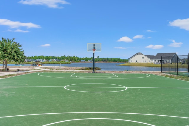 view of basketball court featuring a water view