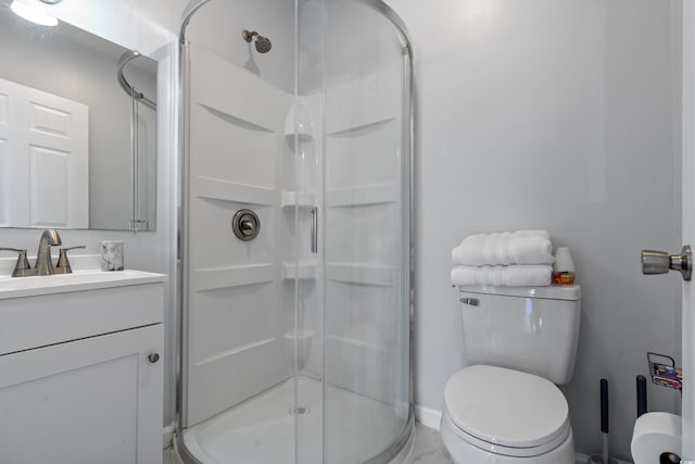 bathroom with vanity, toilet, and an enclosed shower