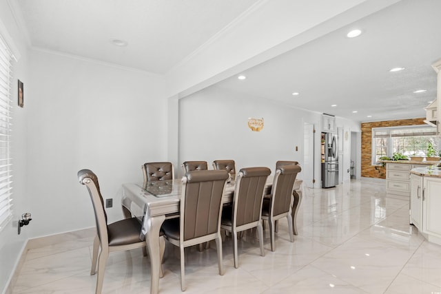 dining room featuring a healthy amount of sunlight and ornamental molding