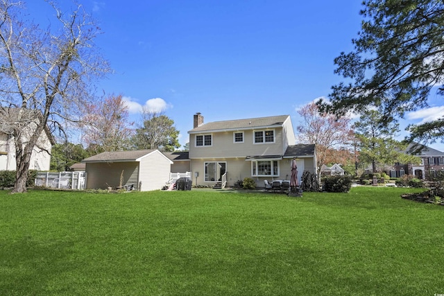 back of house featuring a yard