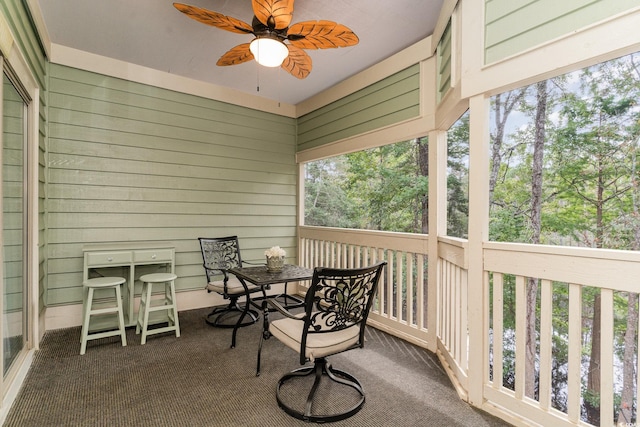 sunroom / solarium featuring ceiling fan