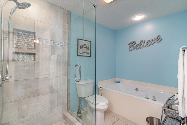 bathroom with a textured ceiling, toilet, tile patterned flooring, and shower with separate bathtub