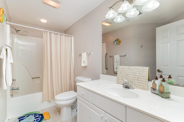 full bathroom featuring tile patterned flooring, toilet, shower / tub combo with curtain, vanity, and a textured ceiling