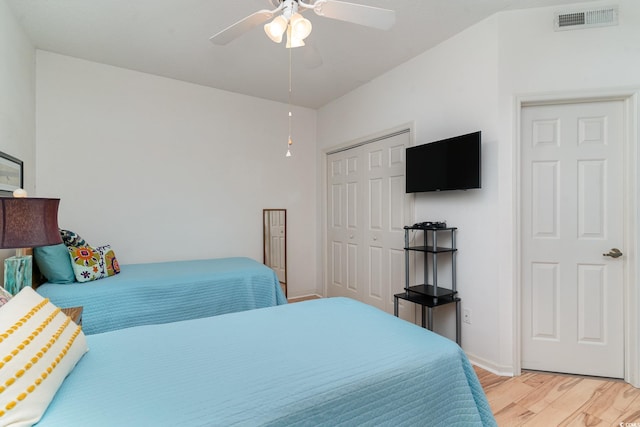 bedroom with a closet, ceiling fan, and light hardwood / wood-style floors