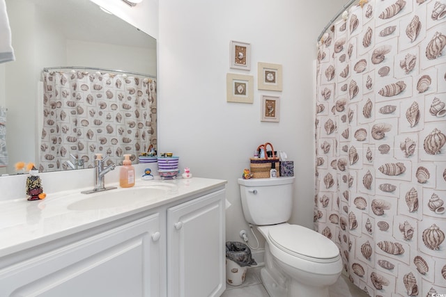 bathroom with tile patterned flooring, vanity, and toilet