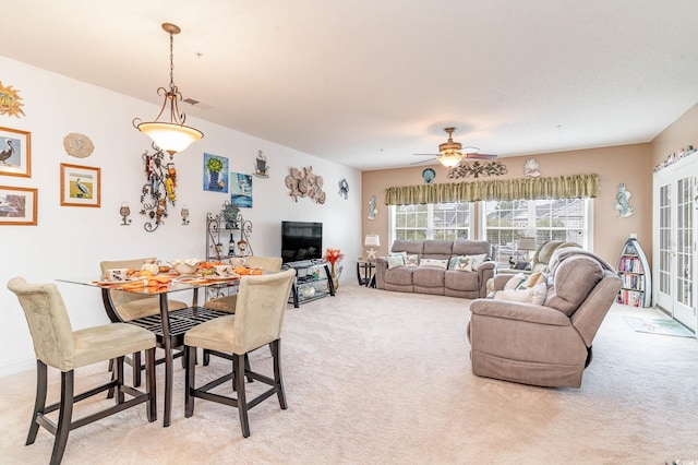 carpeted dining space featuring ceiling fan