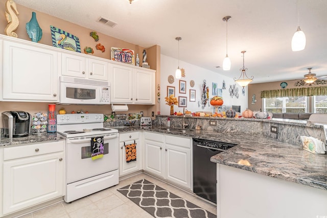 kitchen featuring hanging light fixtures, dark stone countertops, white cabinets, white appliances, and ceiling fan