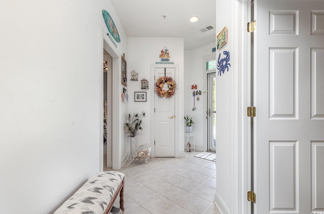 hall featuring light tile patterned floors