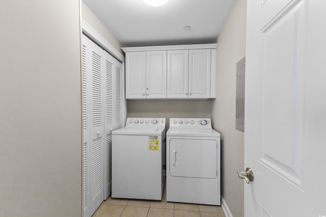 washroom featuring cabinets, electric panel, independent washer and dryer, and light tile patterned floors