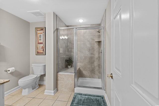 bathroom with tile patterned flooring, a shower with shower door, and toilet