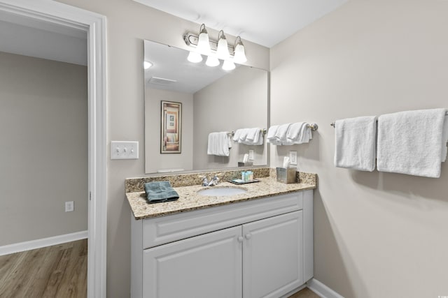 bathroom featuring wood-type flooring and vanity