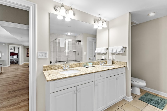 bathroom featuring vanity, hardwood / wood-style floors, an enclosed shower, a chandelier, and toilet