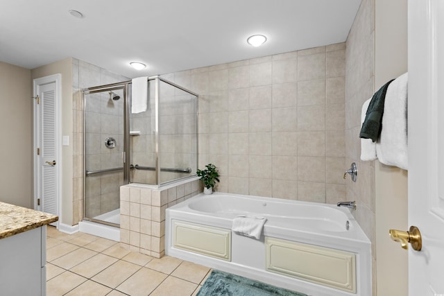 bathroom with plus walk in shower, tile patterned floors, and vanity