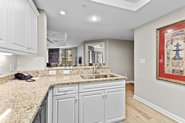 kitchen featuring white cabinetry, ceiling fan, light hardwood / wood-style floors, and sink