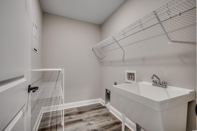 laundry area with electric dryer hookup, wood-type flooring, hookup for a washing machine, and sink