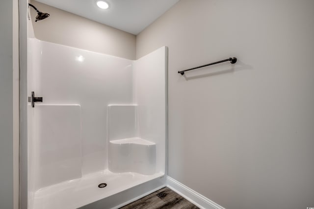 bathroom with hardwood / wood-style floors and walk in shower