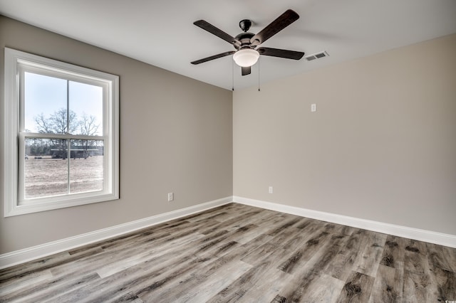 empty room with ceiling fan and light wood-type flooring