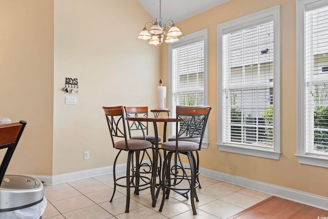 dining area featuring a notable chandelier, light tile patterned flooring, and a healthy amount of sunlight