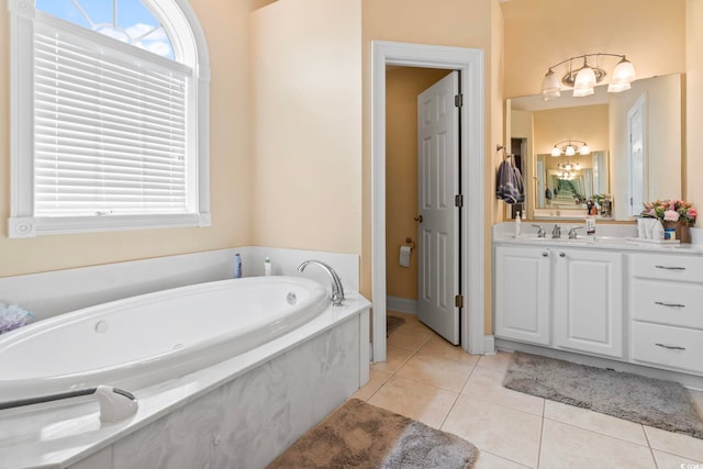 bathroom featuring tile patterned flooring, a bathtub, and vanity