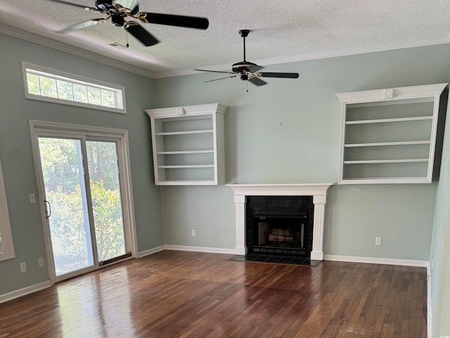 unfurnished living room featuring ceiling fan, ornamental molding, a textured ceiling, dark hardwood / wood-style floors, and a fireplace