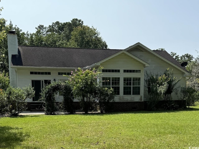 back of house featuring a yard