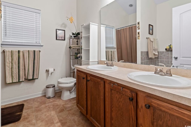 bathroom with vanity, toilet, and tile patterned floors