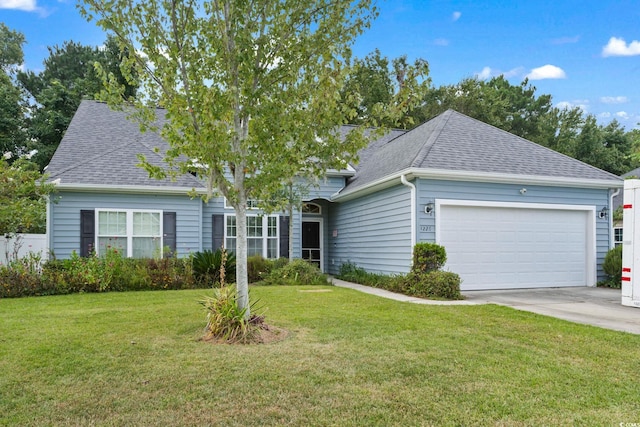 view of front facade with a front yard and a garage