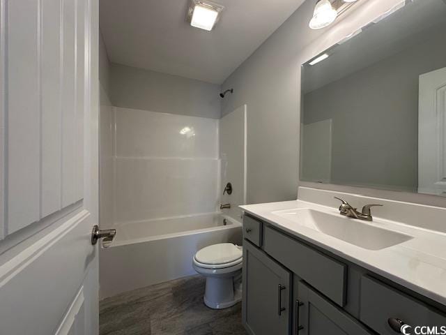 bathroom featuring shower / bathtub combination, vanity, and toilet