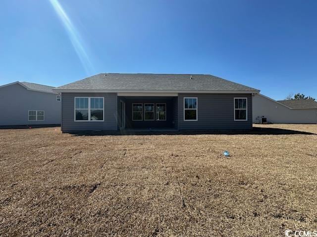 rear view of house with a yard