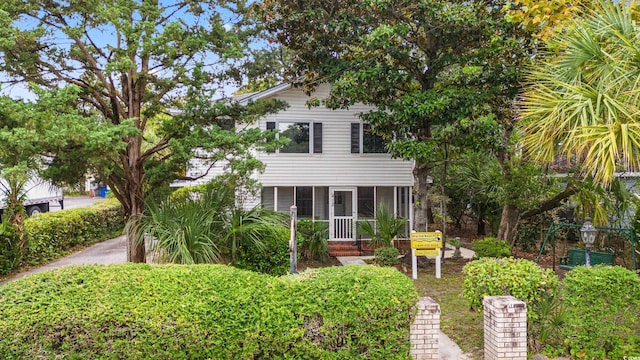 view of front of home featuring a sunroom