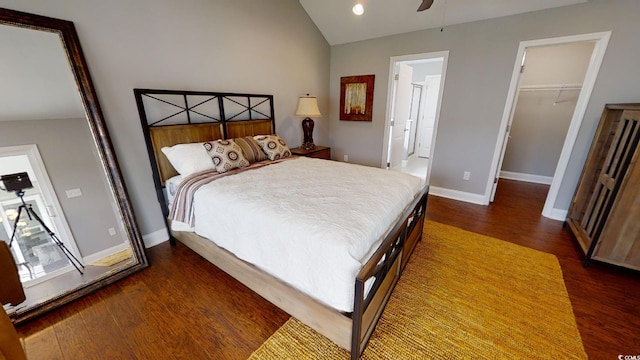 bedroom featuring a closet, lofted ceiling, dark hardwood / wood-style flooring, a spacious closet, and ceiling fan