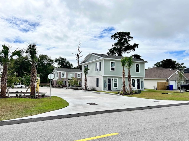 view of front of home featuring a garage and a front yard