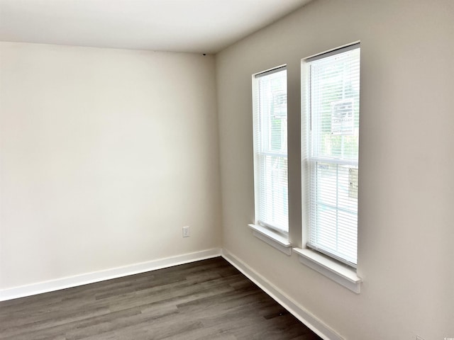 6306 Somerset Dr, Myrtle Beach, SC 29572 - empty room featuring a wealth of natural light, dark wood-style floors, and baseboards