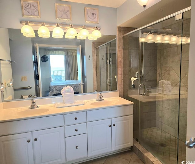 bathroom featuring tile patterned flooring, walk in shower, and vanity