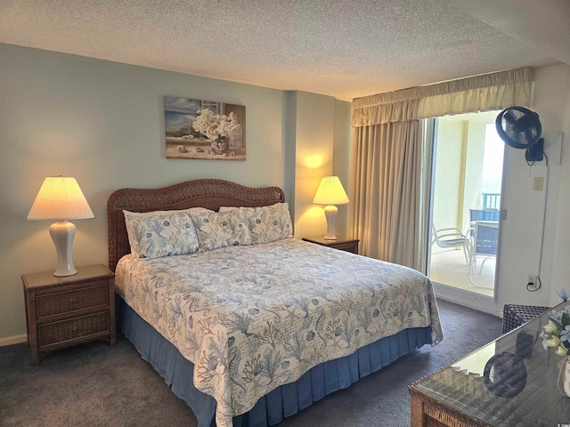 bedroom featuring dark colored carpet, access to exterior, and a textured ceiling