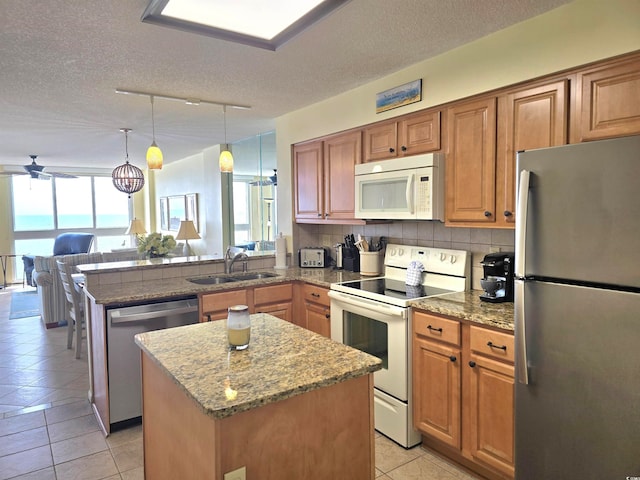 kitchen featuring a kitchen island, plenty of natural light, appliances with stainless steel finishes, and decorative backsplash