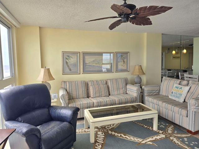 living room featuring a textured ceiling, a healthy amount of sunlight, and ceiling fan