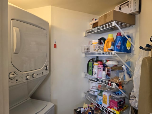 clothes washing area featuring stacked washing maching and dryer