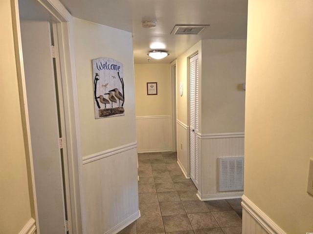 corridor featuring dark tile patterned flooring