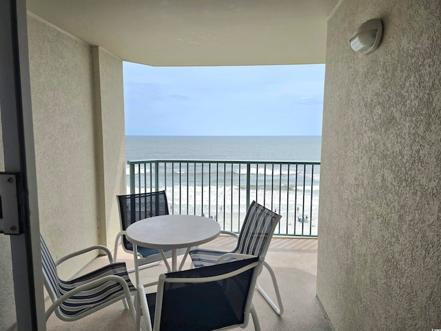 balcony with a beach view and a water view