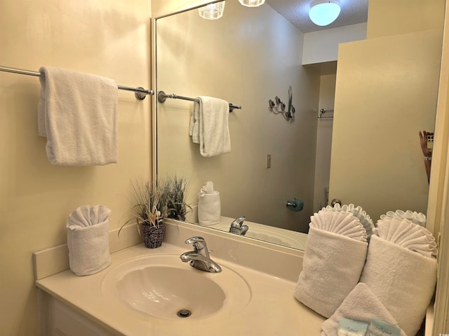 bathroom with a textured ceiling and vanity