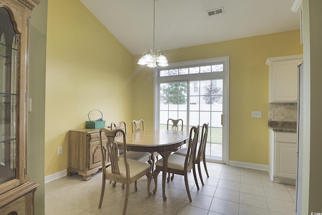 tiled dining room with a notable chandelier and vaulted ceiling