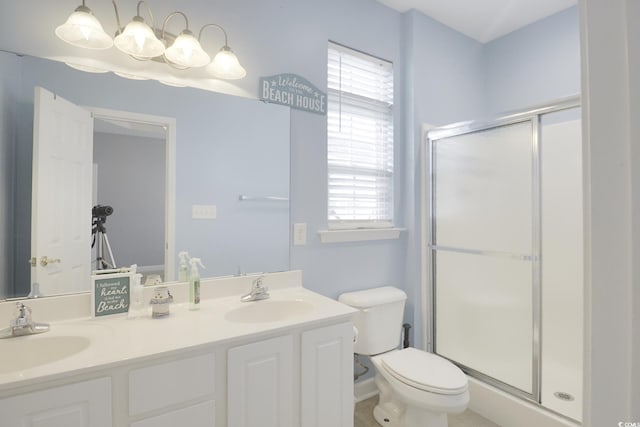 bathroom featuring vanity, toilet, and walk in shower