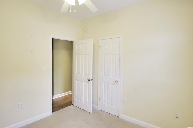 unfurnished bedroom featuring light colored carpet and ceiling fan