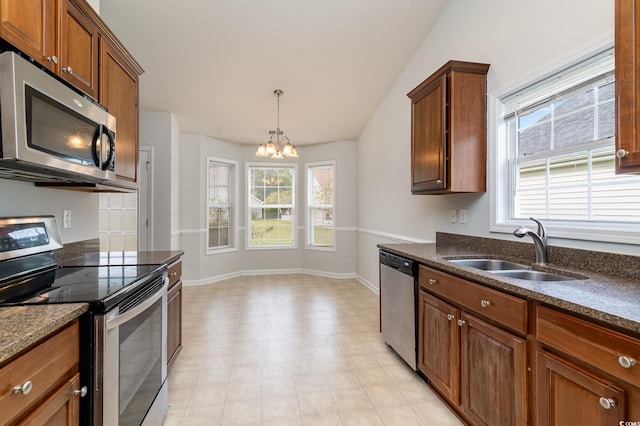 kitchen with sink, a healthy amount of sunlight, a notable chandelier, and appliances with stainless steel finishes