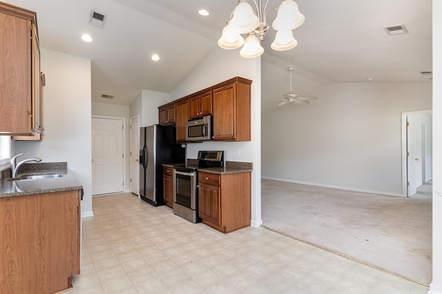 kitchen featuring light carpet, appliances with stainless steel finishes, ceiling fan with notable chandelier, vaulted ceiling, and sink